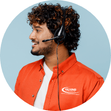 smiling Kevins Worldwide client support specialist wearing a headset and orange button down shirt